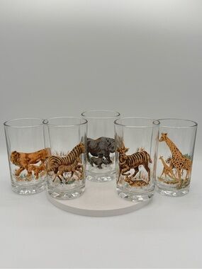 Set of five vintage Pasari glass tumblers with African wildlife decals.